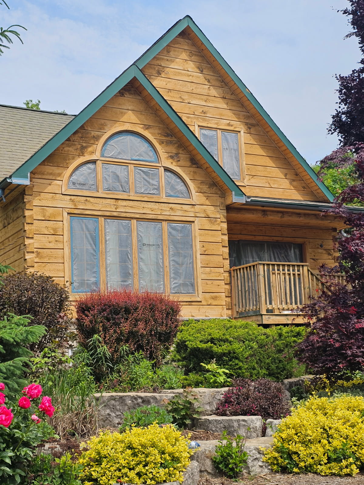 Professional log home staining in Barrie
