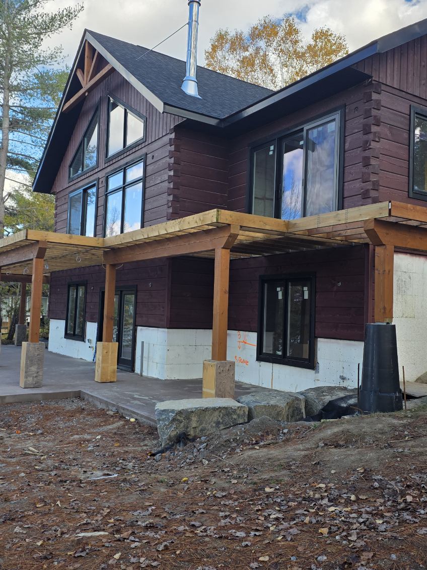 Freshly stained log home exterior with timber porch